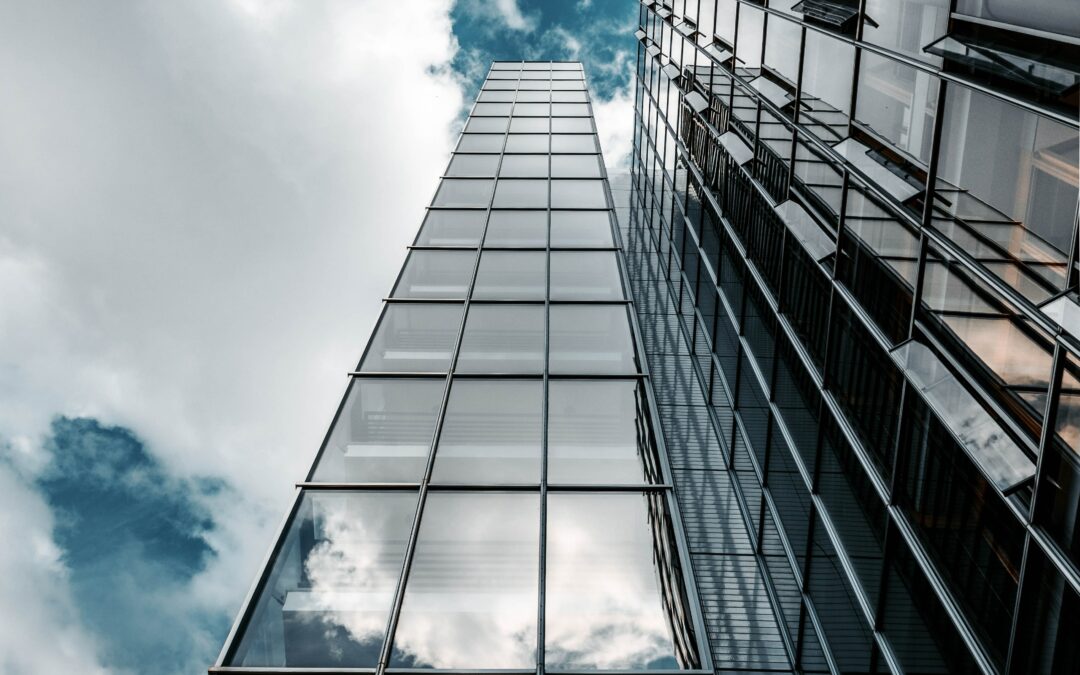 Photo of a skyscraper building and partly cloudy sky