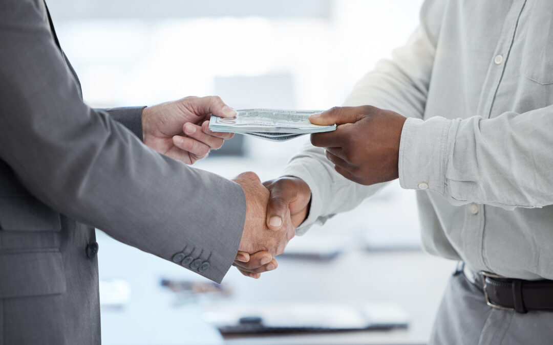 A close-up of a person handing over money